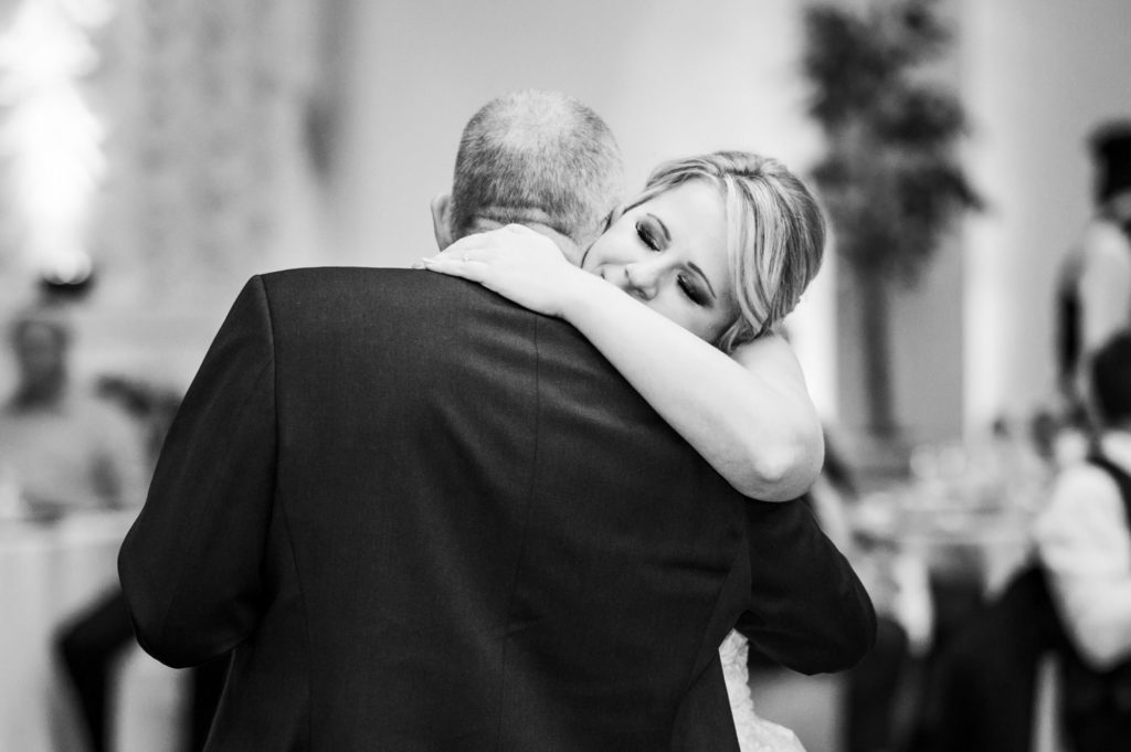 bride hugging father during father daughter dance 