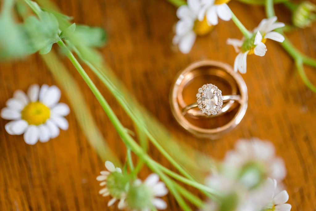 engagement ring and wedding ring stack with daisys at windy spring charlottesville wedding 