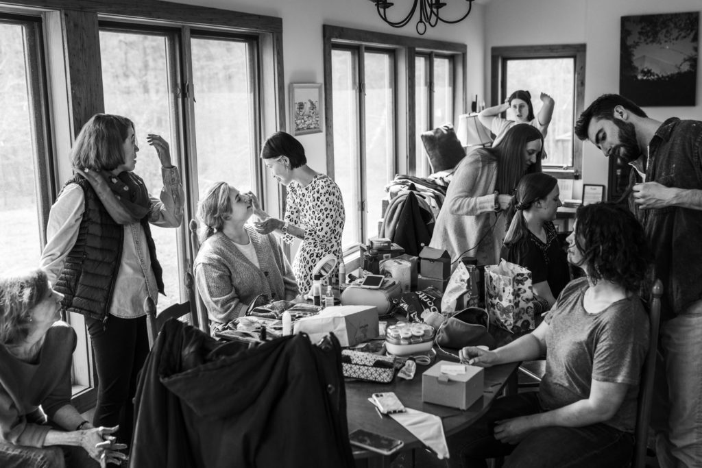 black and white portrait of wedding party getting ready before windy spring wedding 