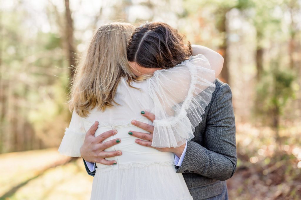 bride and groom hugging after emotional first look