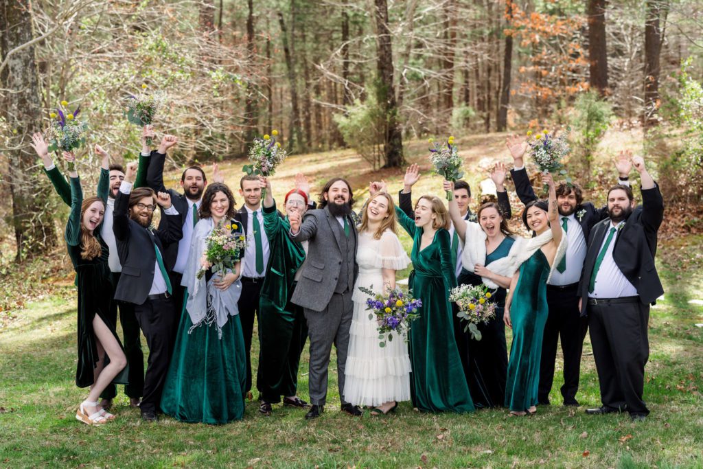 family portraits with family wearing emerald green dresses and gray suits before windy spring charlottesville wedding 