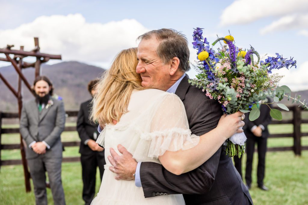 bride hugging father before getting married 