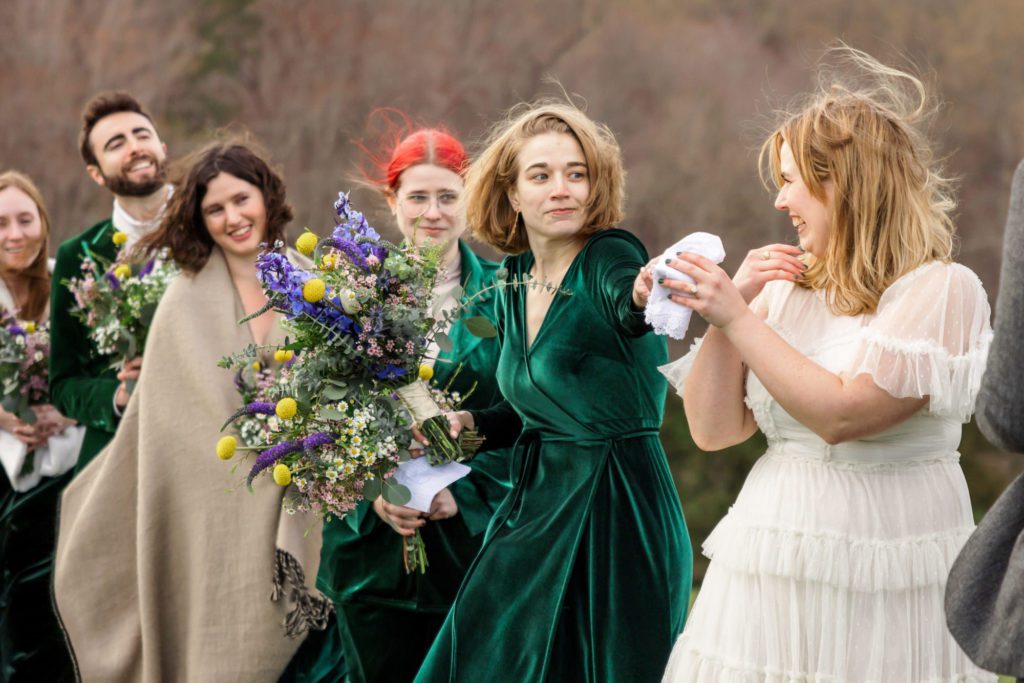 bride looking to bridesmaids for tissue and vows