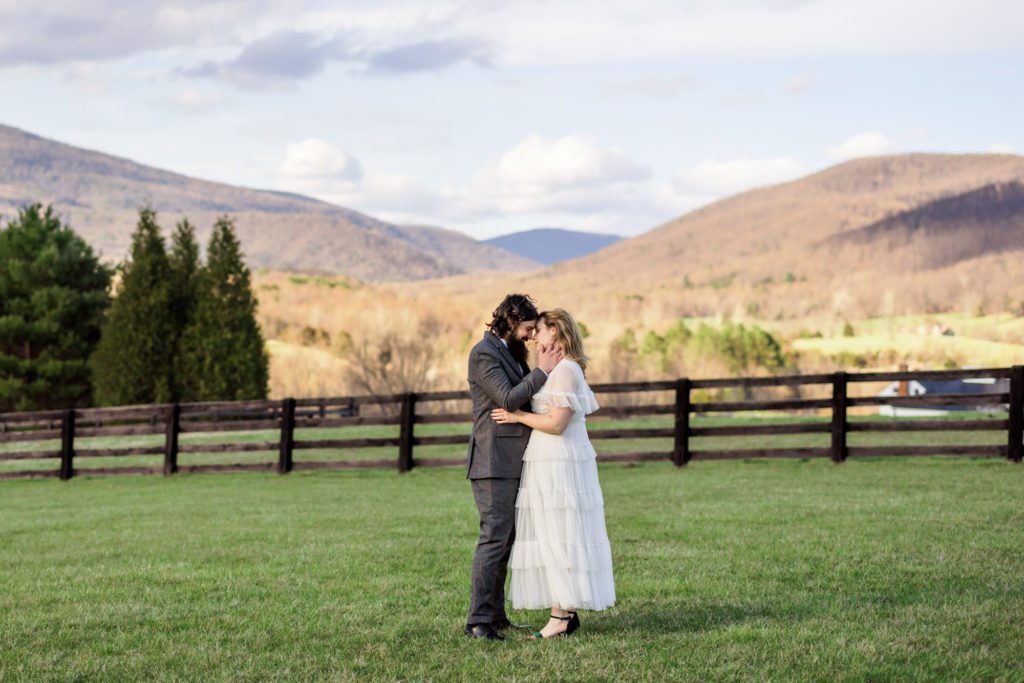 couple foreheads together during outdoor portraits after windy spring charlottesville wedding ceremony