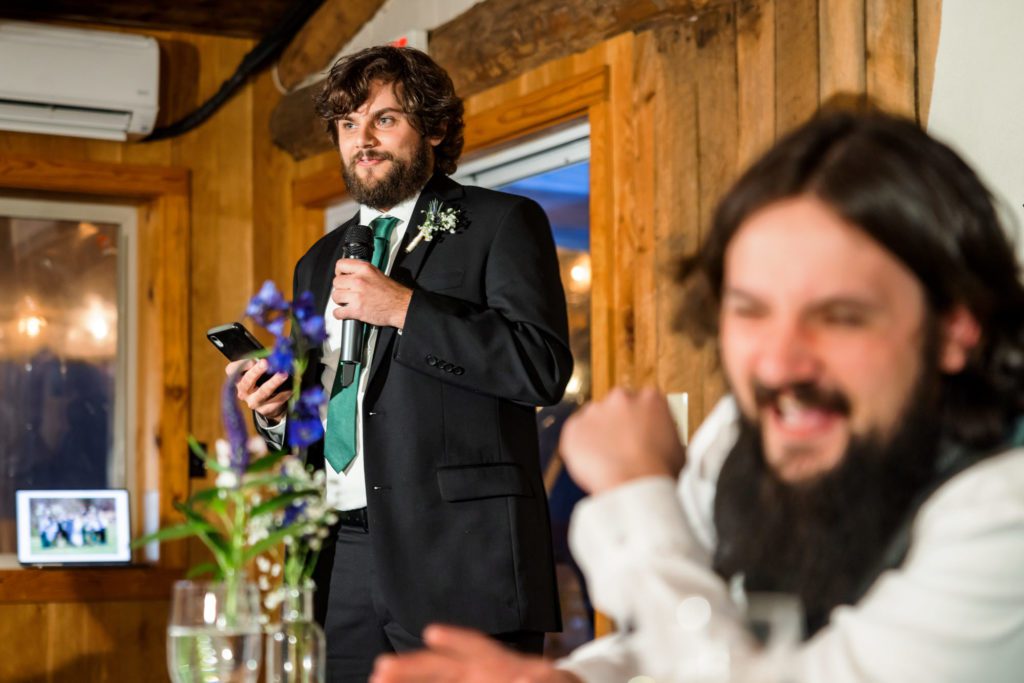 groomsmen giving toast with groom laughing in background