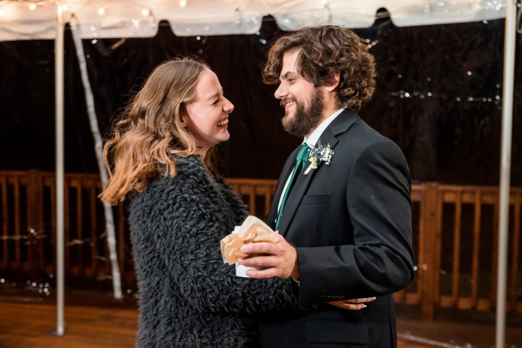 couple dancing trying to stay warm during windy wedding reception