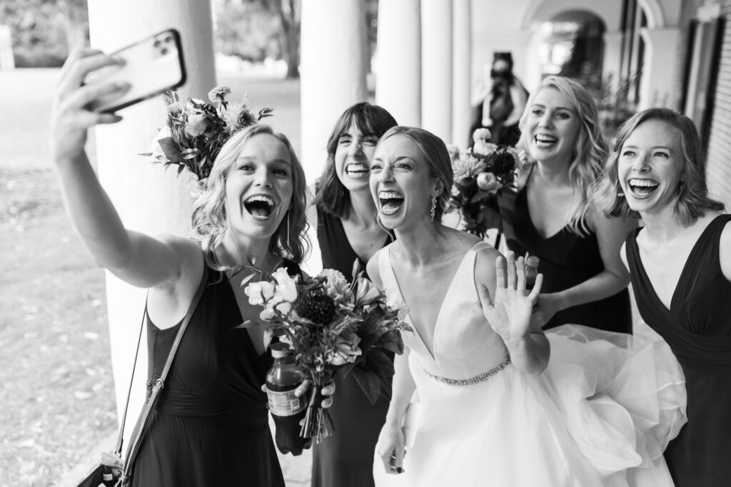 Bride facetiming with wedding party on wedding day 