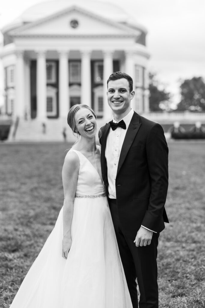 black and white portrait of couple standing in front of UVA during portraits