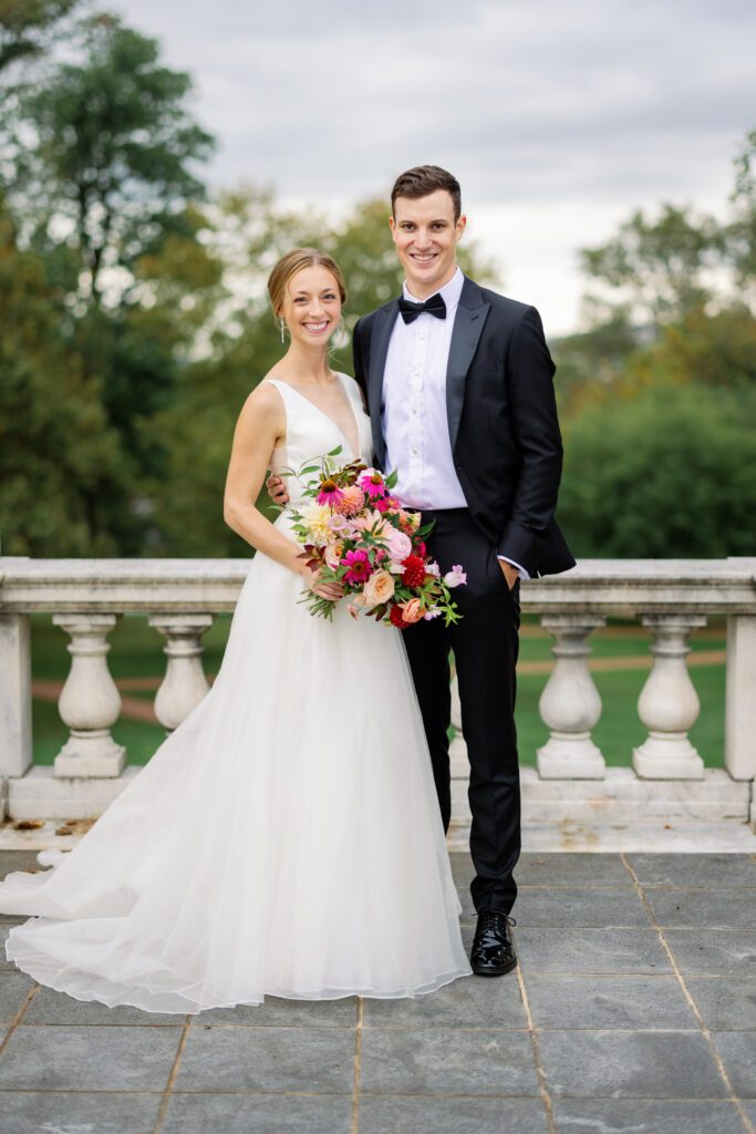 bride and groom standing together in wedding dress and black tuxedo