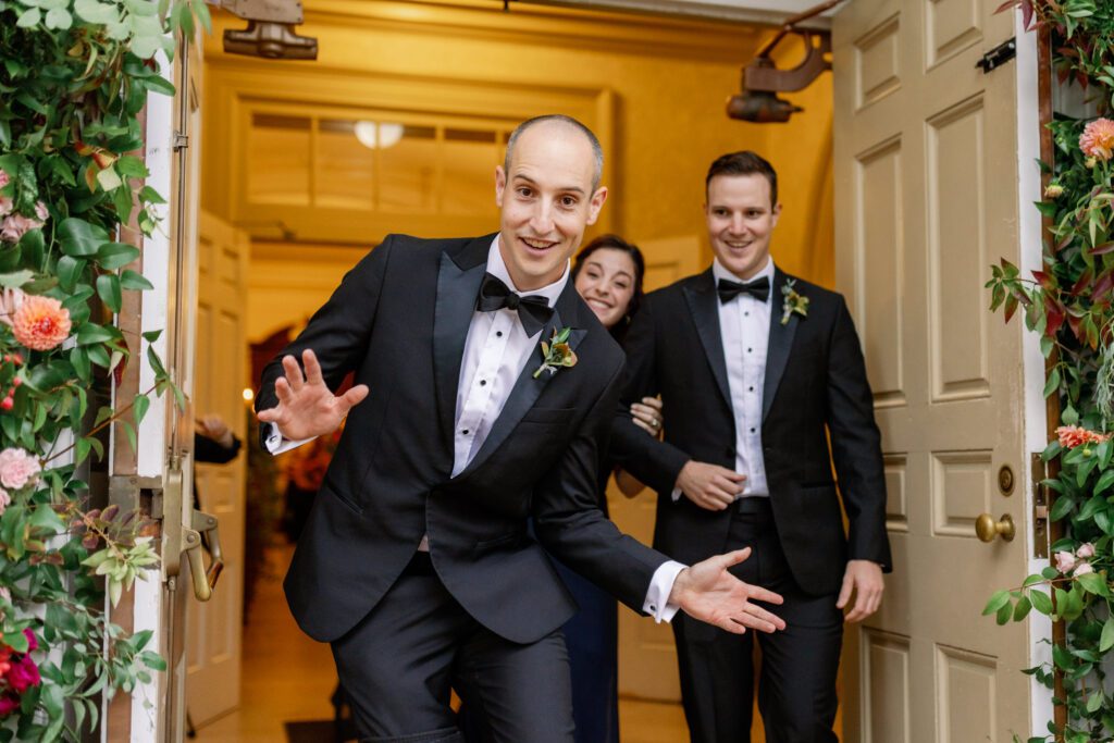 groomsmen exiting wedding ceremony in black tuxedoes 