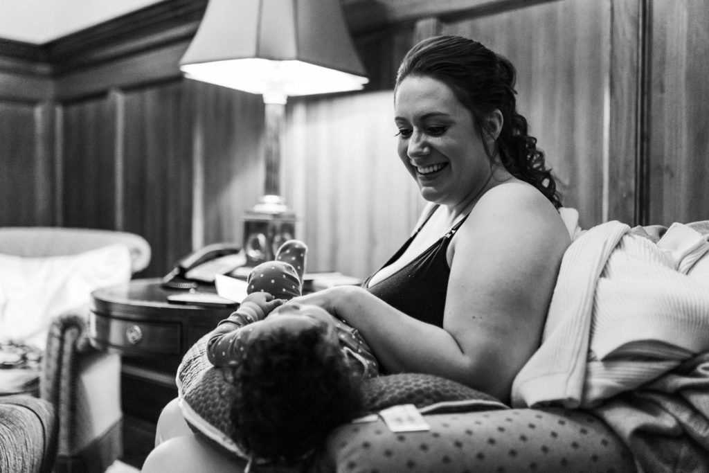 bride sitting in chair and holding young daughter smiling and laughing together