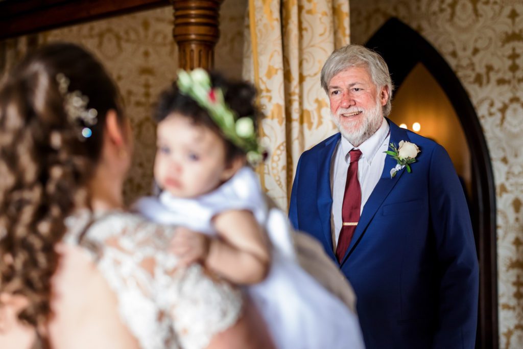 bride's father seeing bride and granddaughter for first time on wedding day