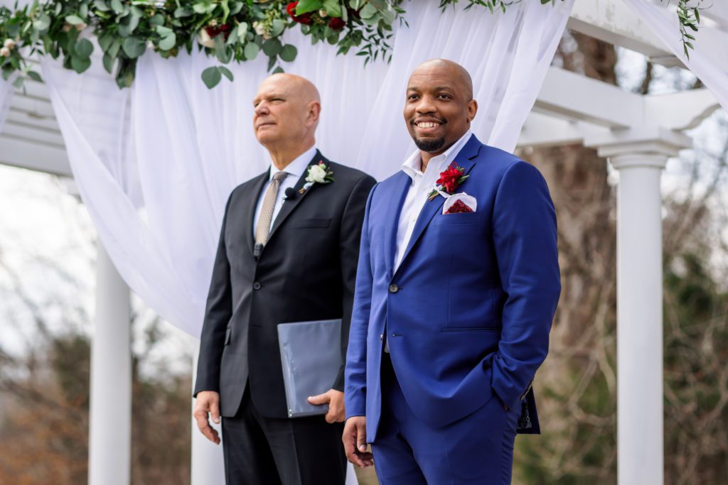 groom standing at ceremony waiting for bride to walk down aisle