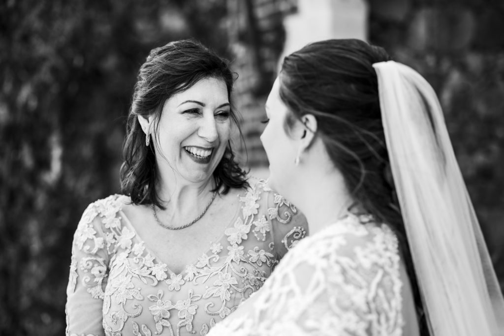 bride and mother laughing and smiling together