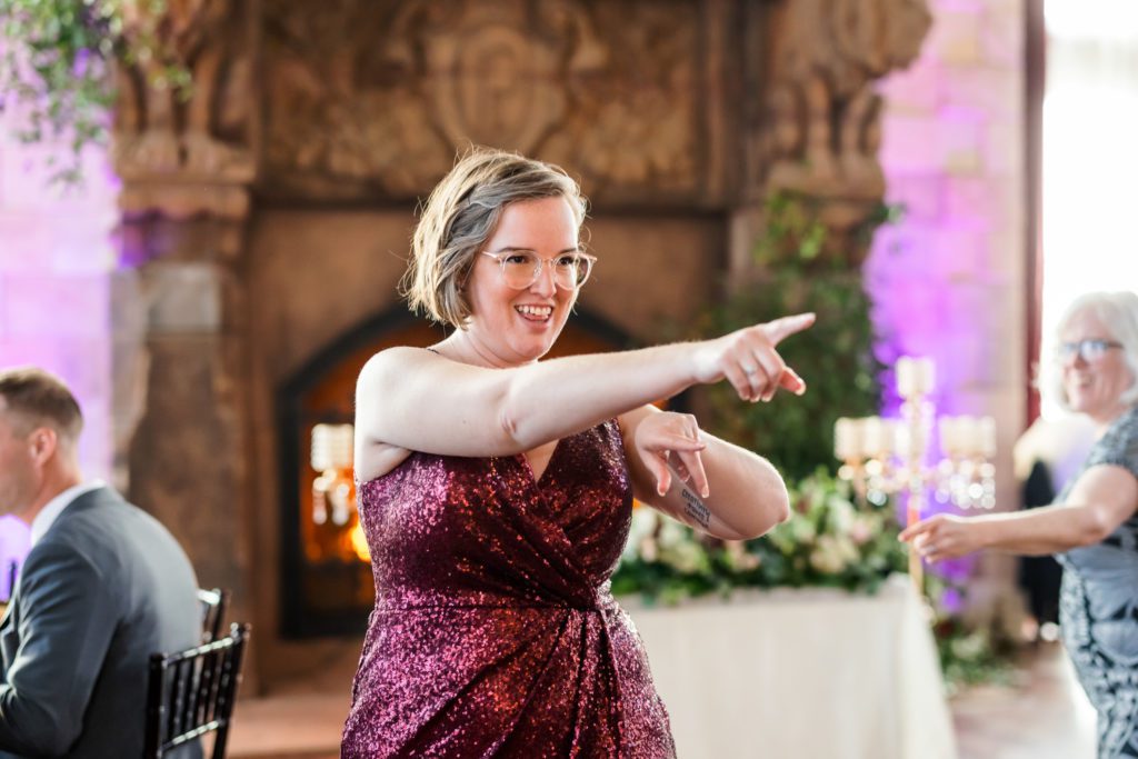 woman pointing and dancing during wedding reception at spring dover hall wedding 