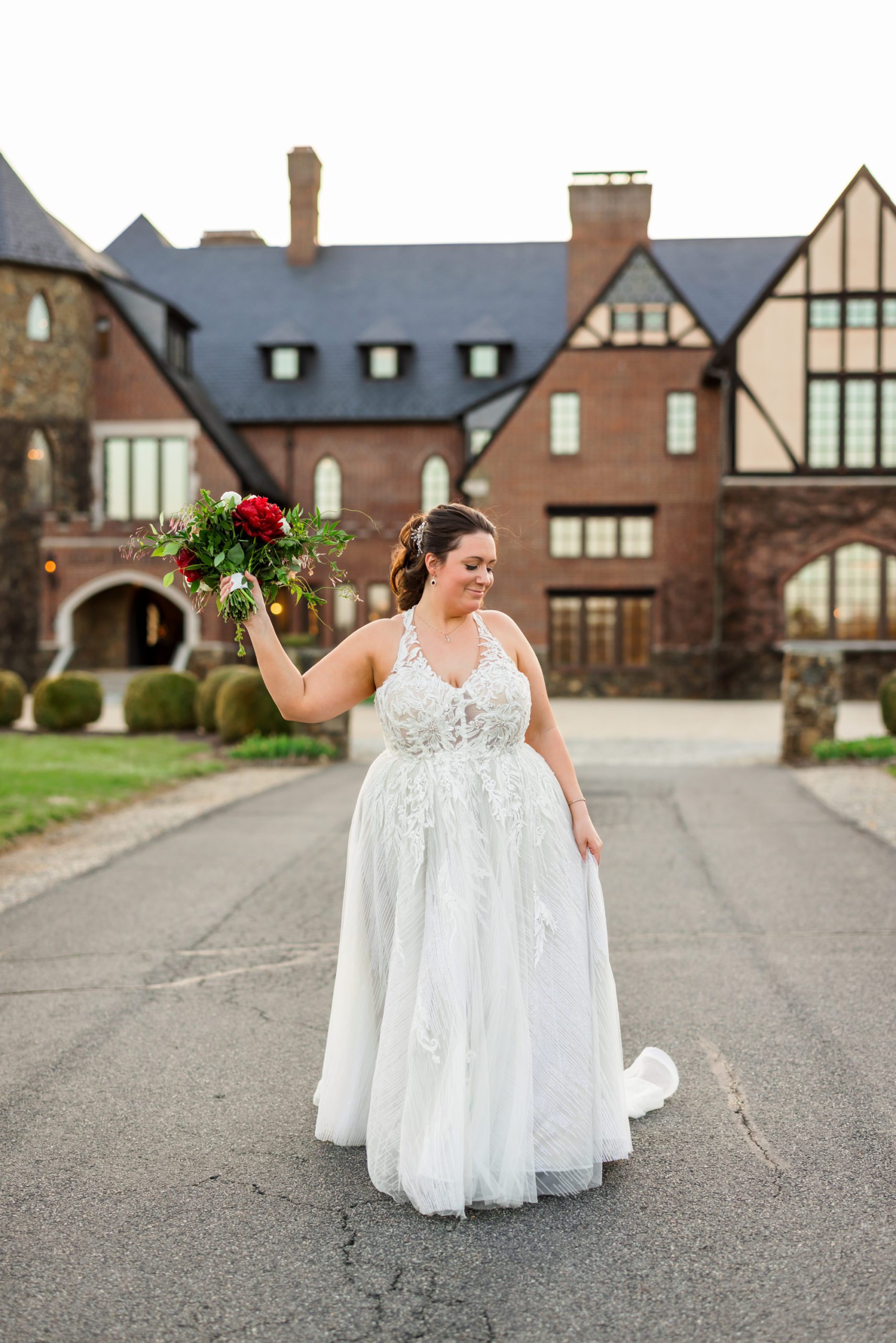 bride holding bouquet and smiling during outdoor bridals