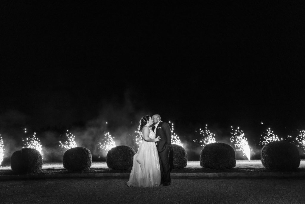 newly married couple kissing during firework send off at spring dover hall wedding