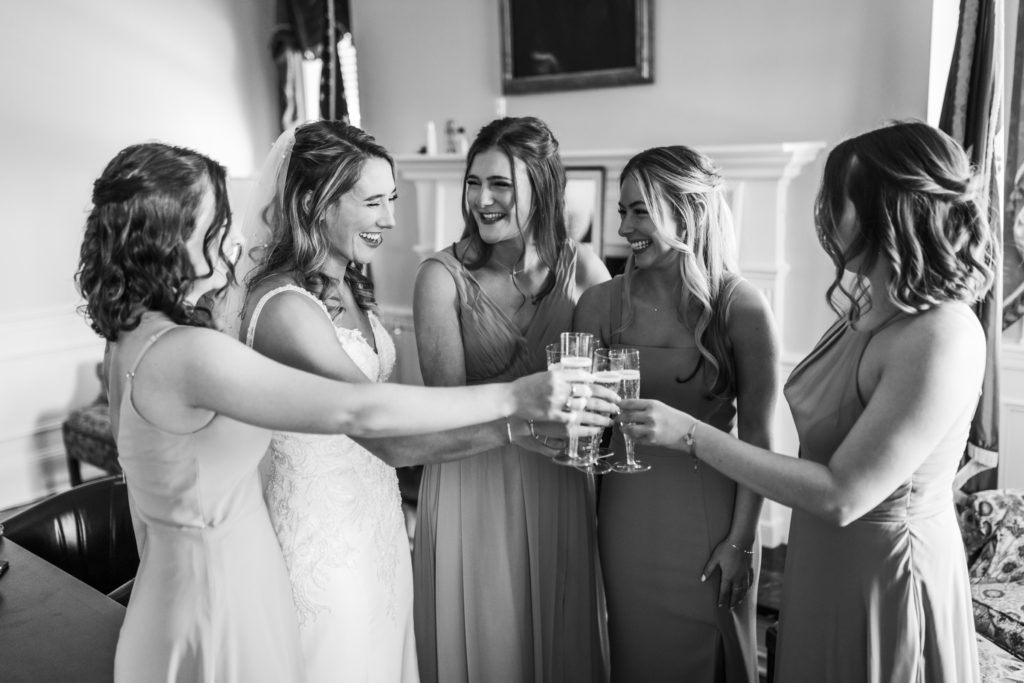 bride toasting with bridesmaids after getting ready