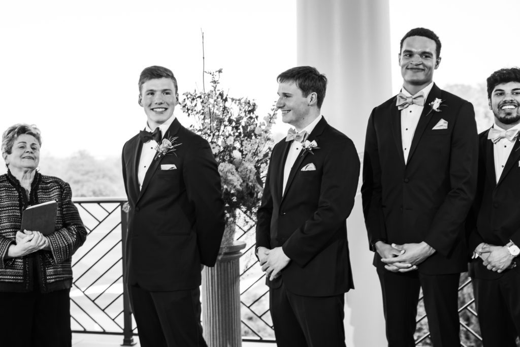 groom standing with groomsmen before wedding ceremonymsmen 