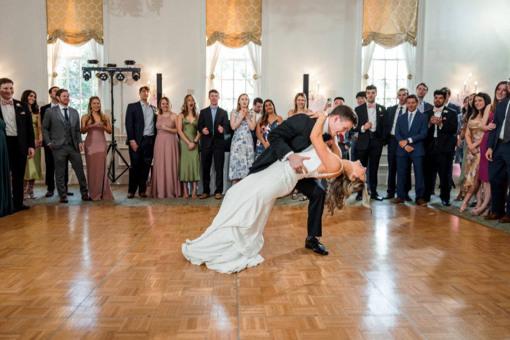 groom dipping bride during first dance as husband and wife