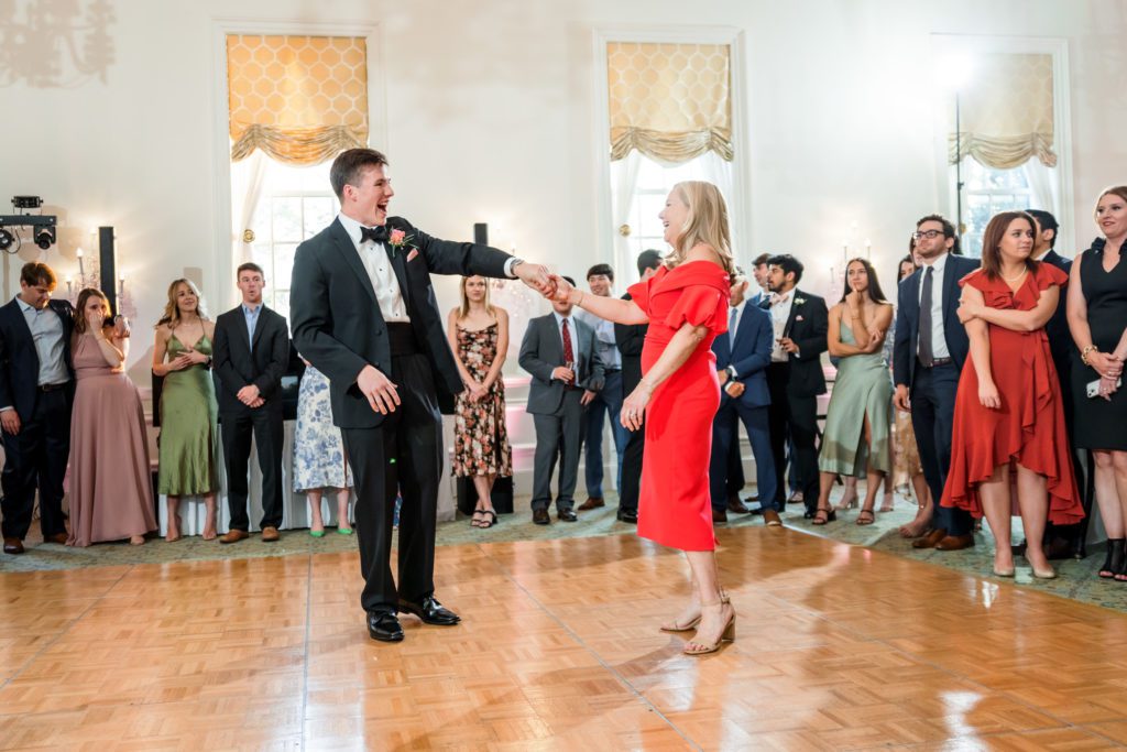 groom dancing with mother during mother and son dance at elegant spring washington golf and country club wedding