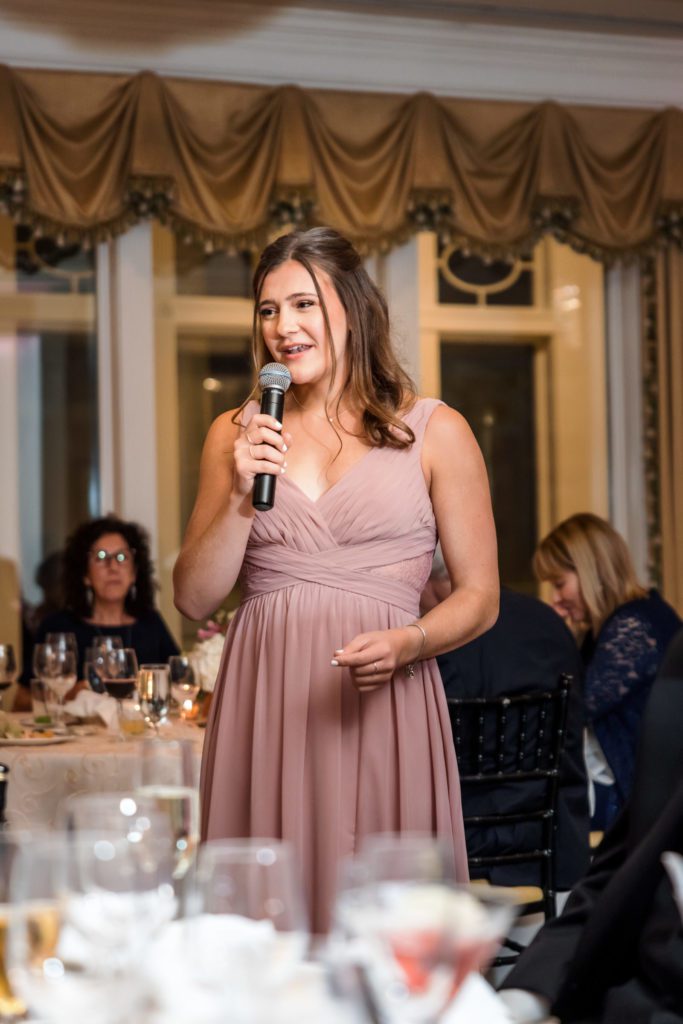 bridesmaid talking into microphone giving speech at elegant spring washington golf and country club wedding reception