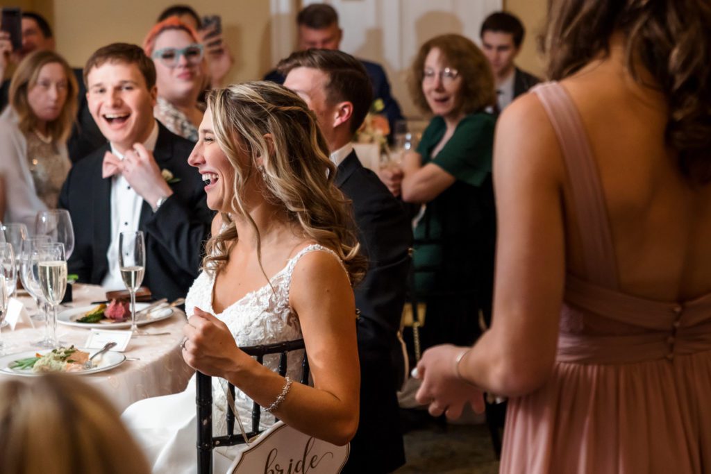 wedding couple laughing during wedding speeches