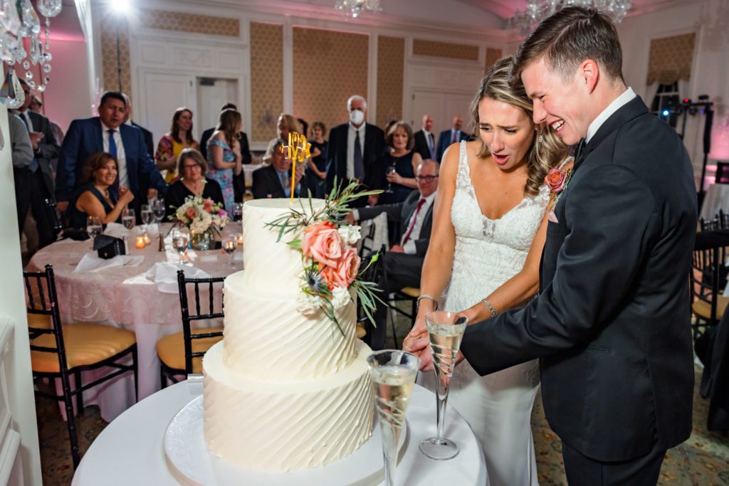 wedding couple cutting cake at wedding reception