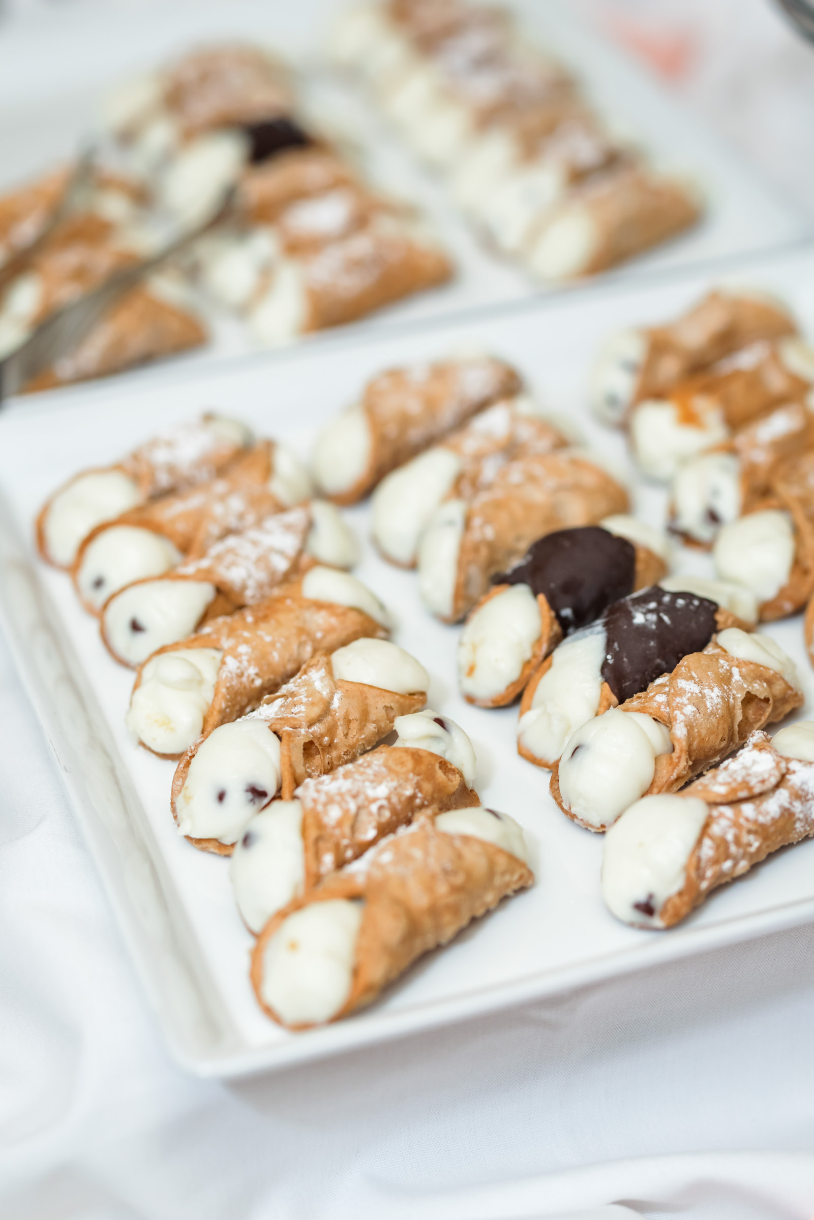 plate of cannolis with chocolate chips on dessert table