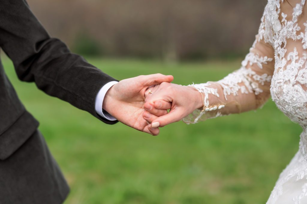 bride and groom holding hands after romantic first look