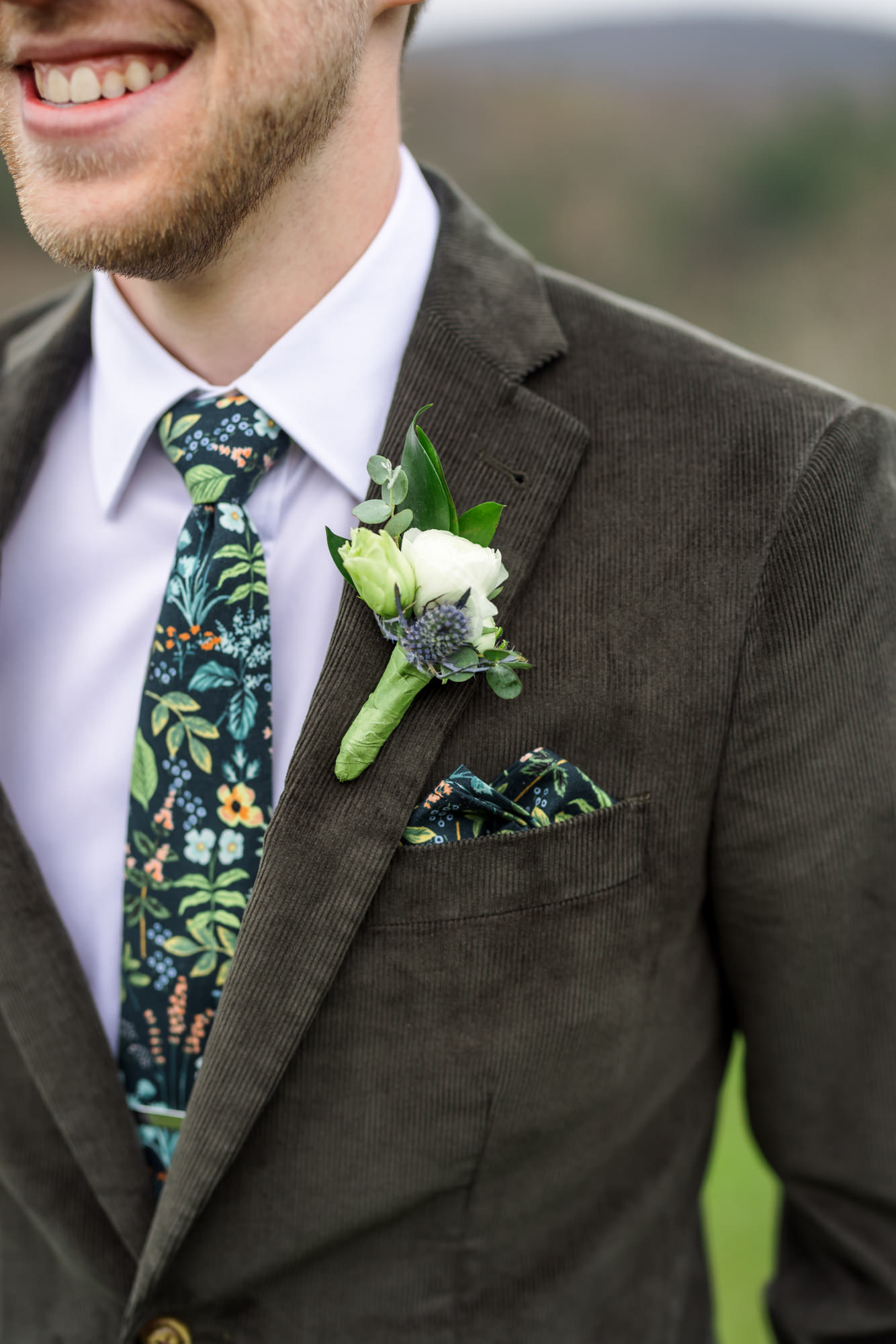 close up of groom's tie and boutonniere