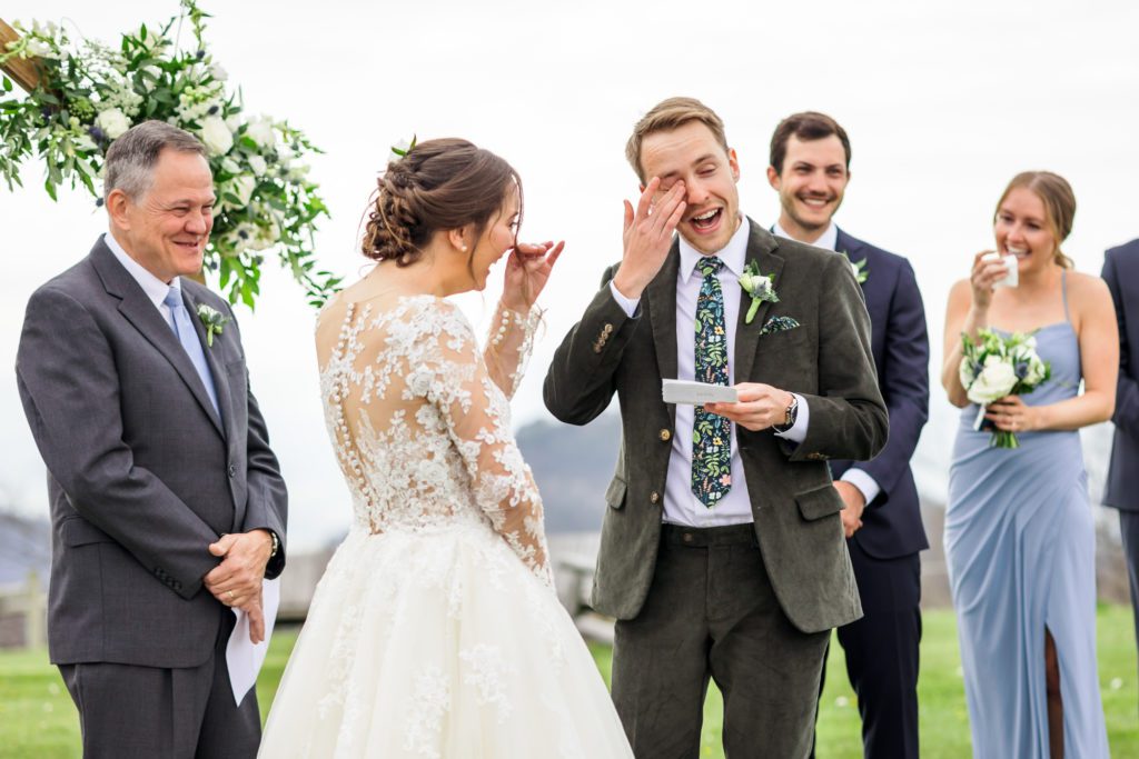 wedding couple both getting emotional during outdoor wedding ceremony at 12 Ridges Vineyard wedding
