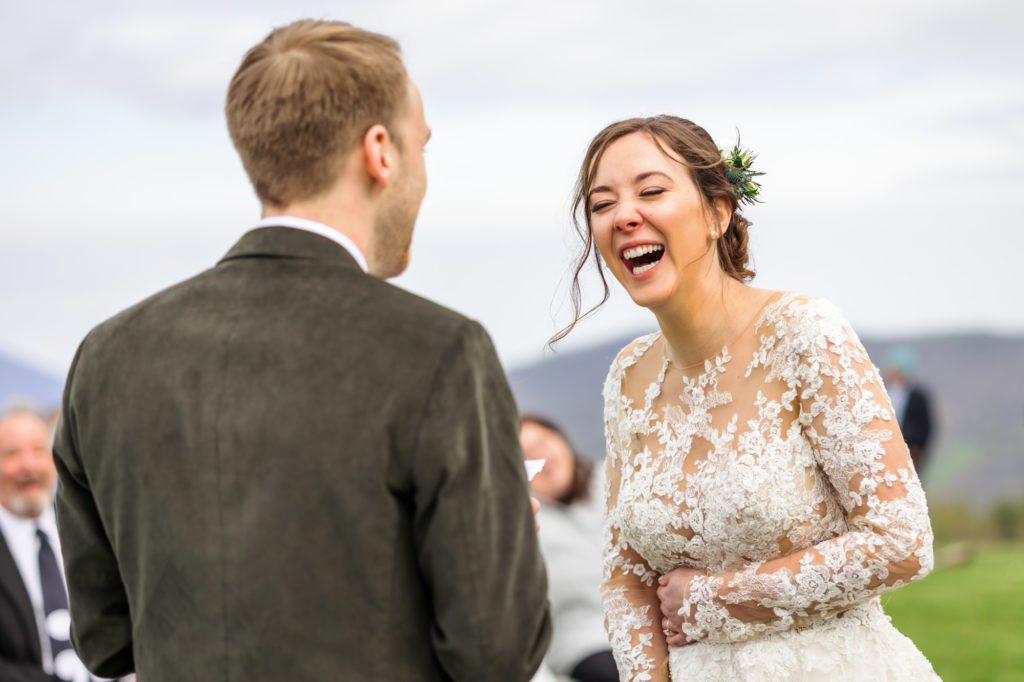 bride laughing during outdoor wedding ceremony at 12 Ridges vineyard wedding 