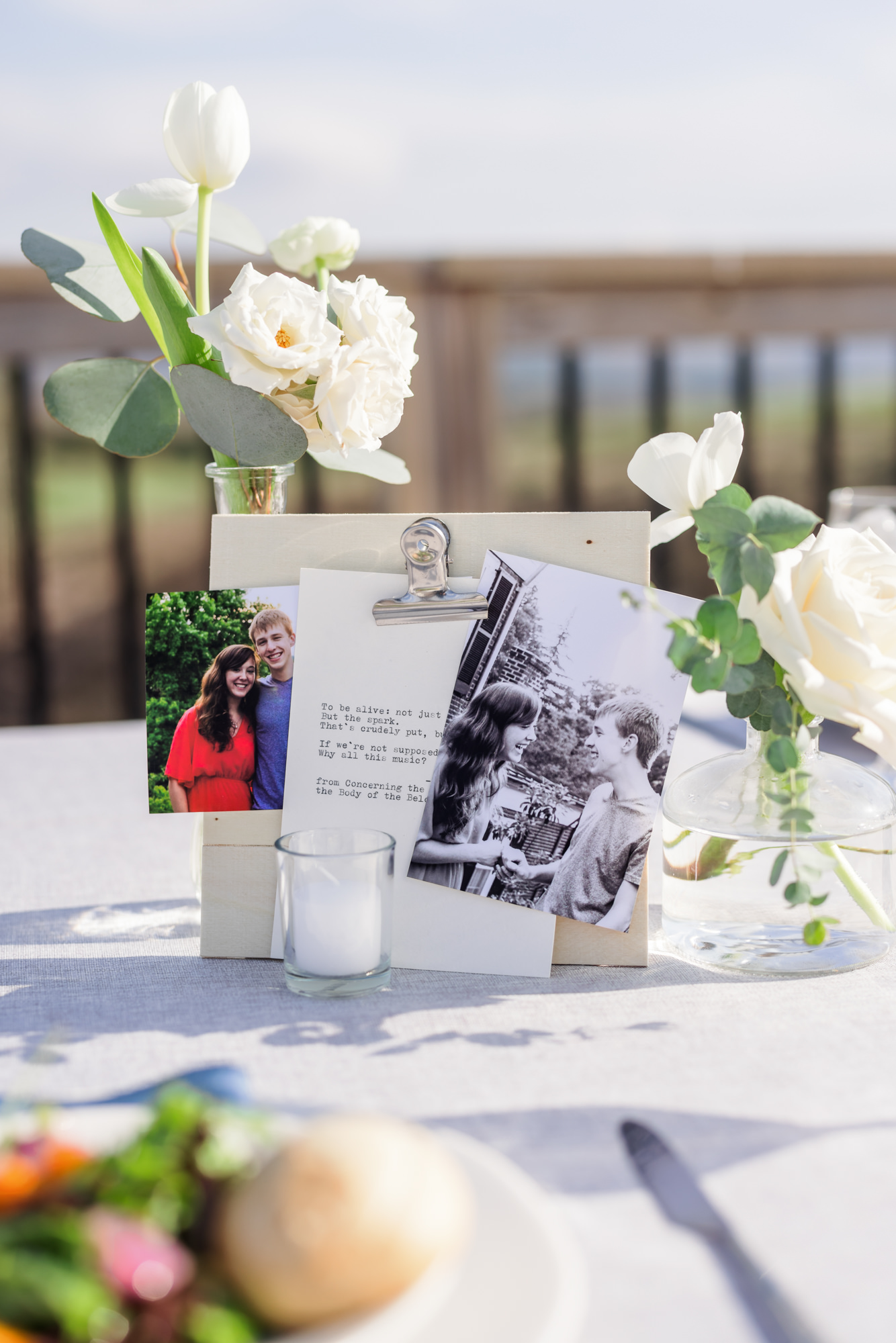 close up of simple wedding centerpieces with pictures and clipboard 