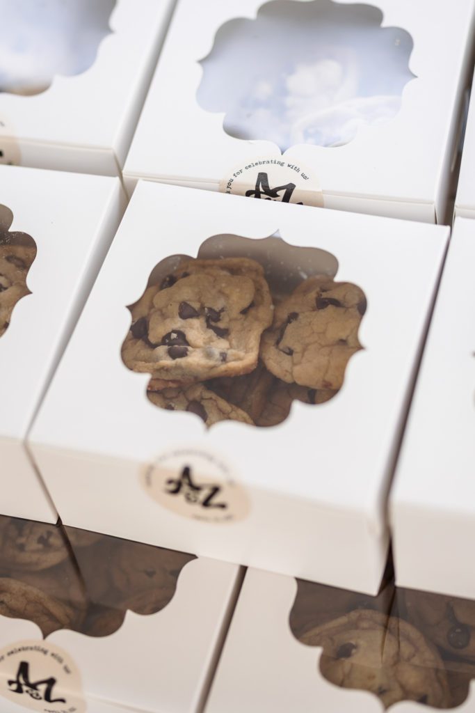 boxes of homemade chocolate chip cookies for guests to enjoy during outdoor spring 12 Ridges Vineyard wedding reception