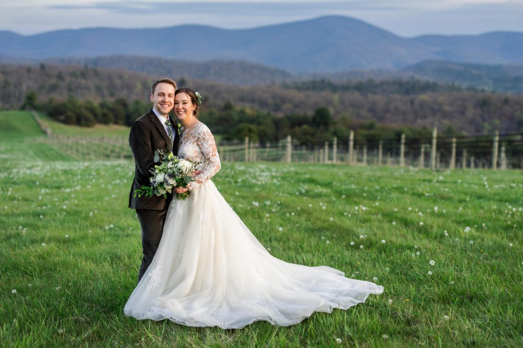 bride and groom standing together in grassy field after spring 12 Ridges Vineyard Wedding