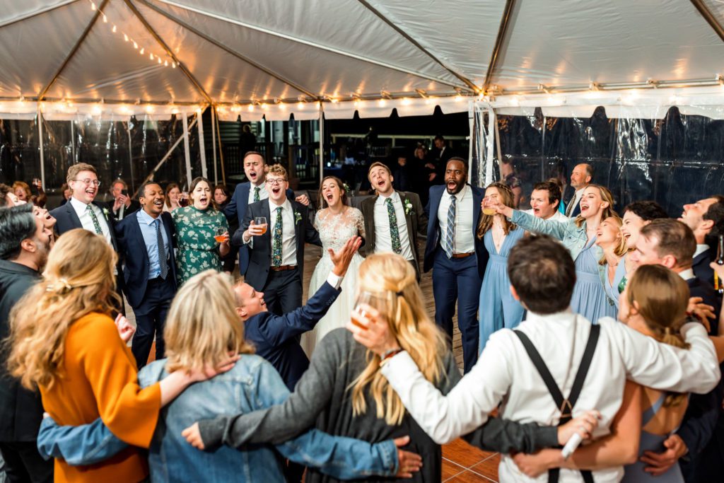 wedding guests laughing and celebrating together at spring 12 ridges vineyard wedding reception