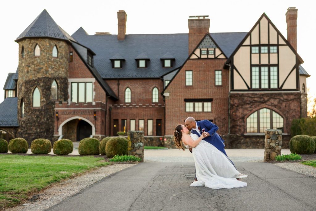wedding couple kissing in front of Dover Hall one of Richmond's top wedding venues