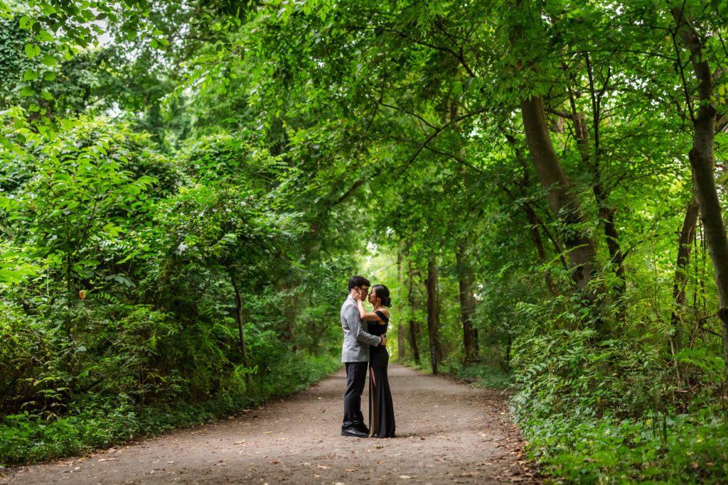 couple slow dancing in the trees surrounded by luscious greenery