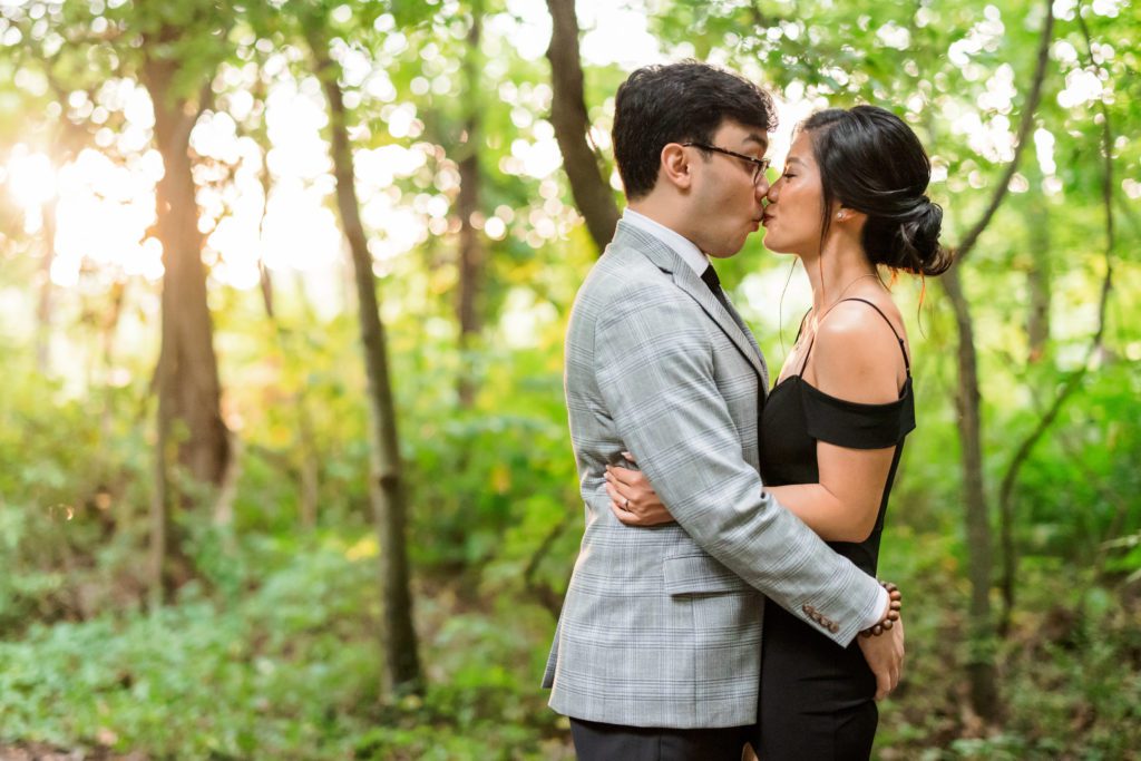 newly engaged couple kiss during outdoor engagement portraits