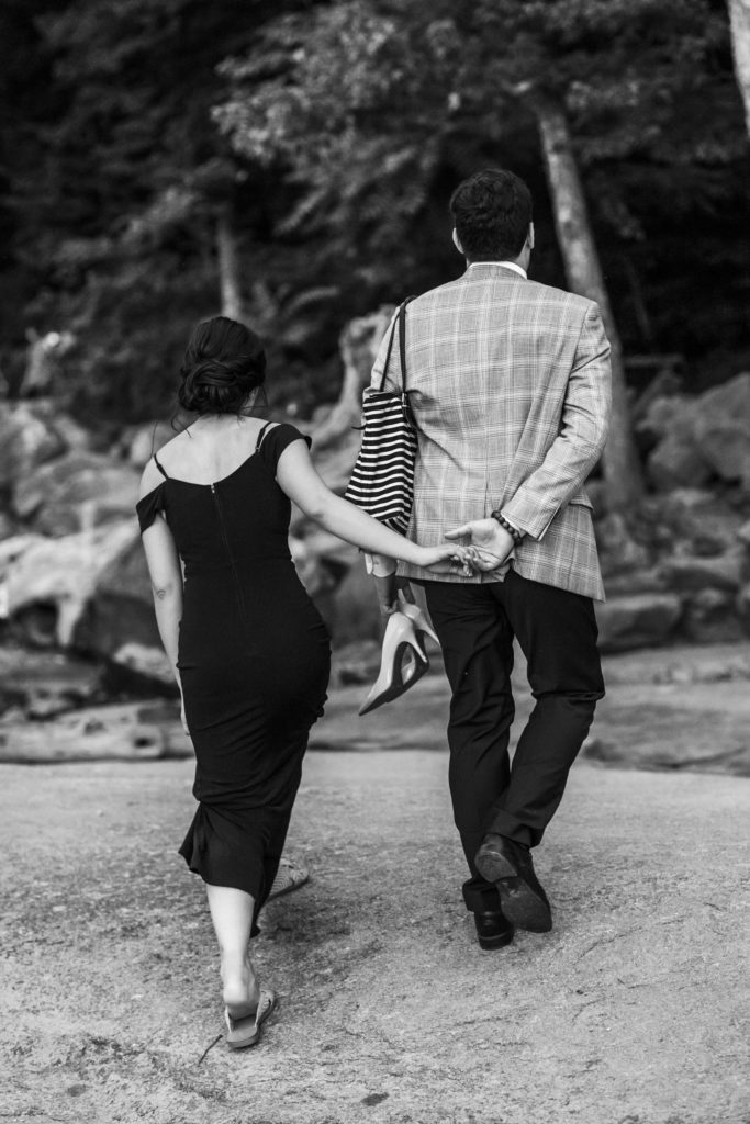 engaged couple walking hand in hand 