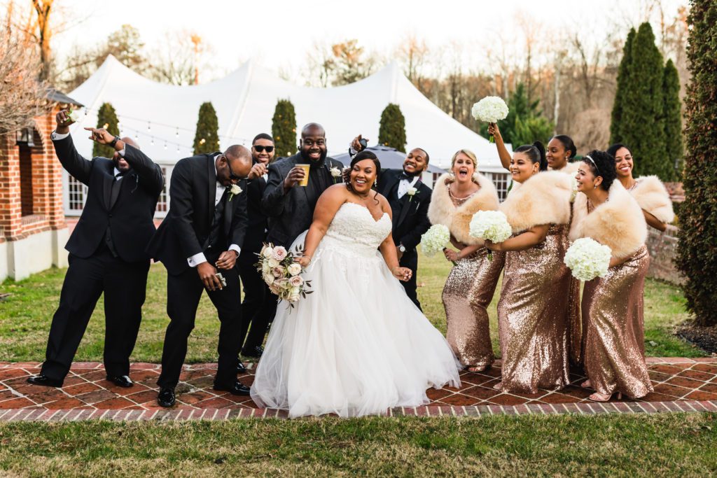 bride and groom having fun with bridal party at one of the top Richmond wedding venues