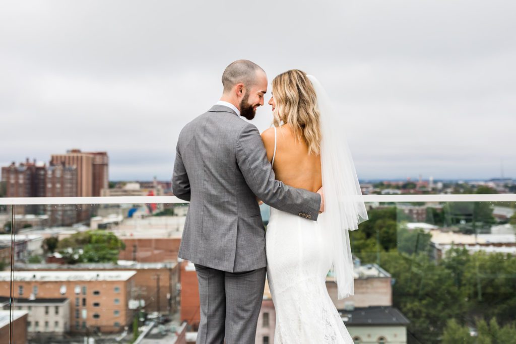 bride and groom embracing at top of quirk hotel, one of the top Richmond wedding venues
