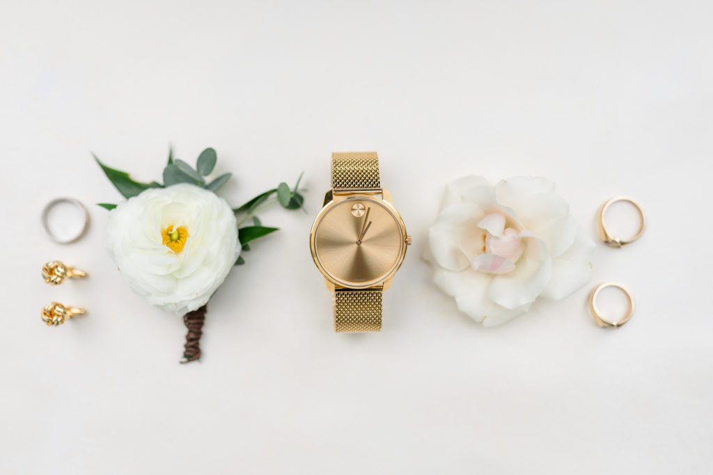 bridal details with boutonnière with gold watches and jewelry  