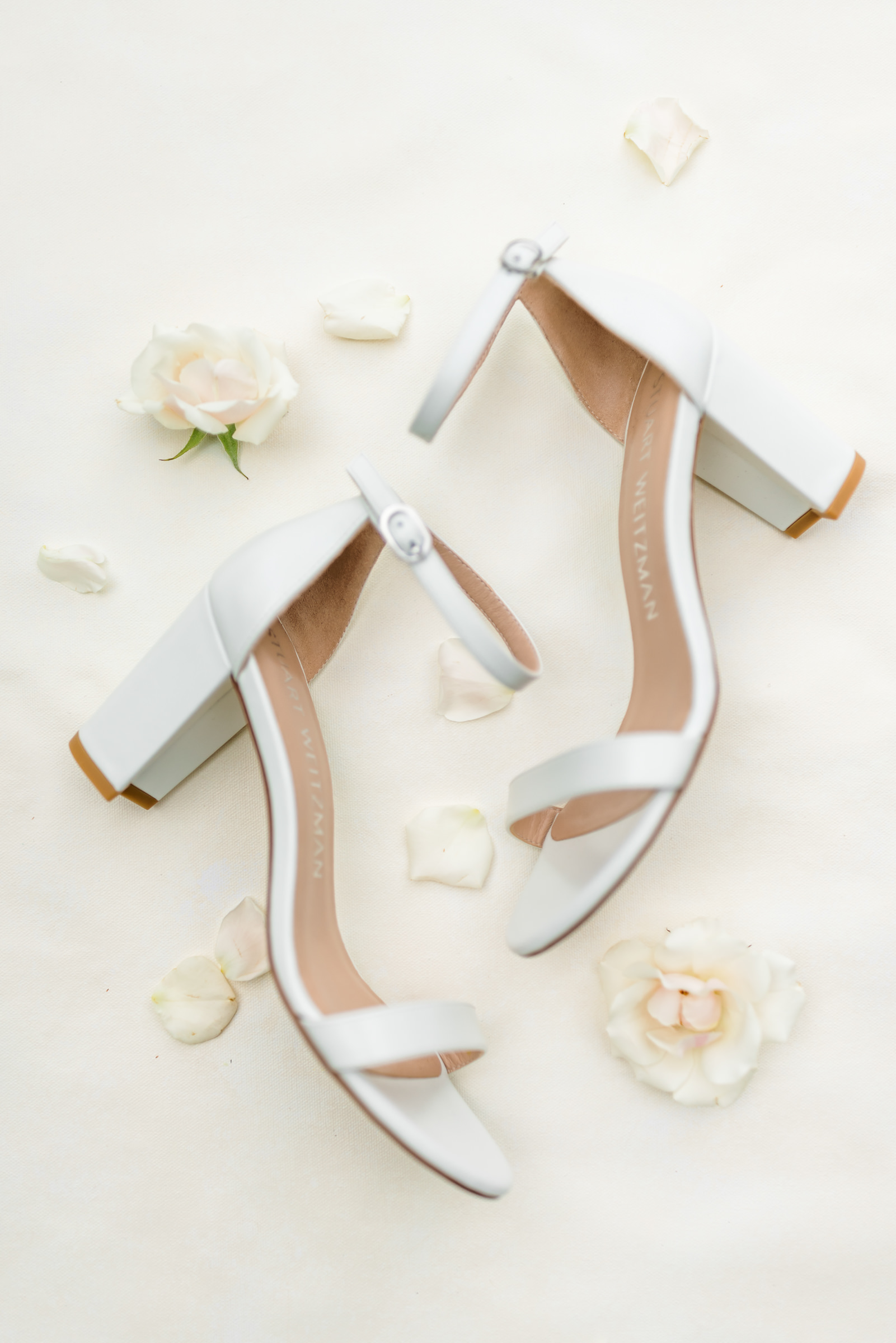 white bridal shoes with flowers and bridal details