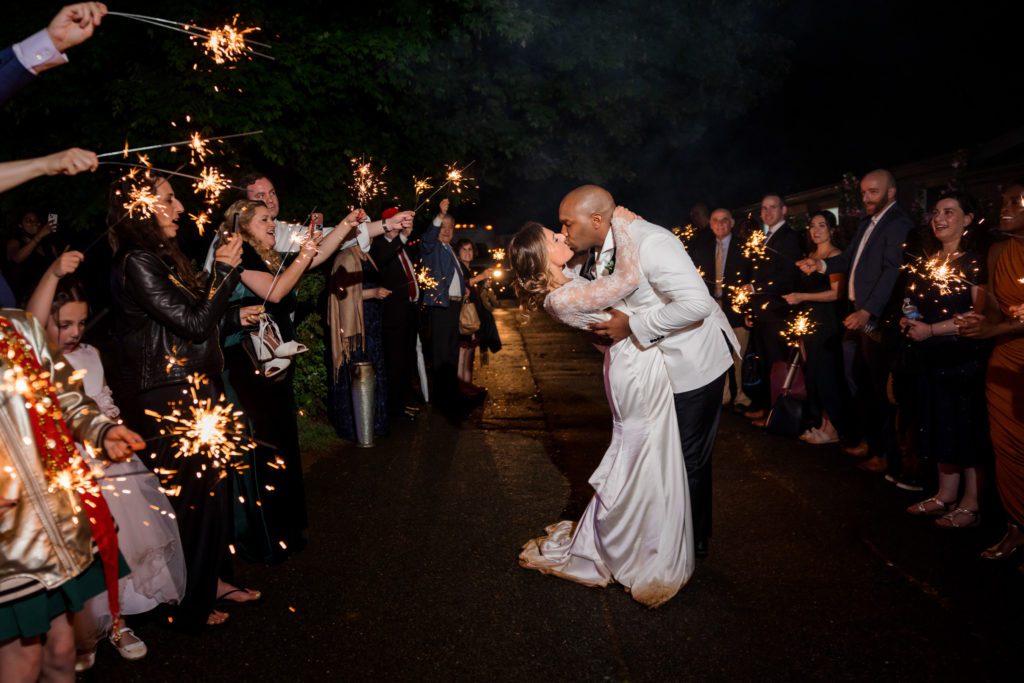 wedding couple kissing during sparkler exit 