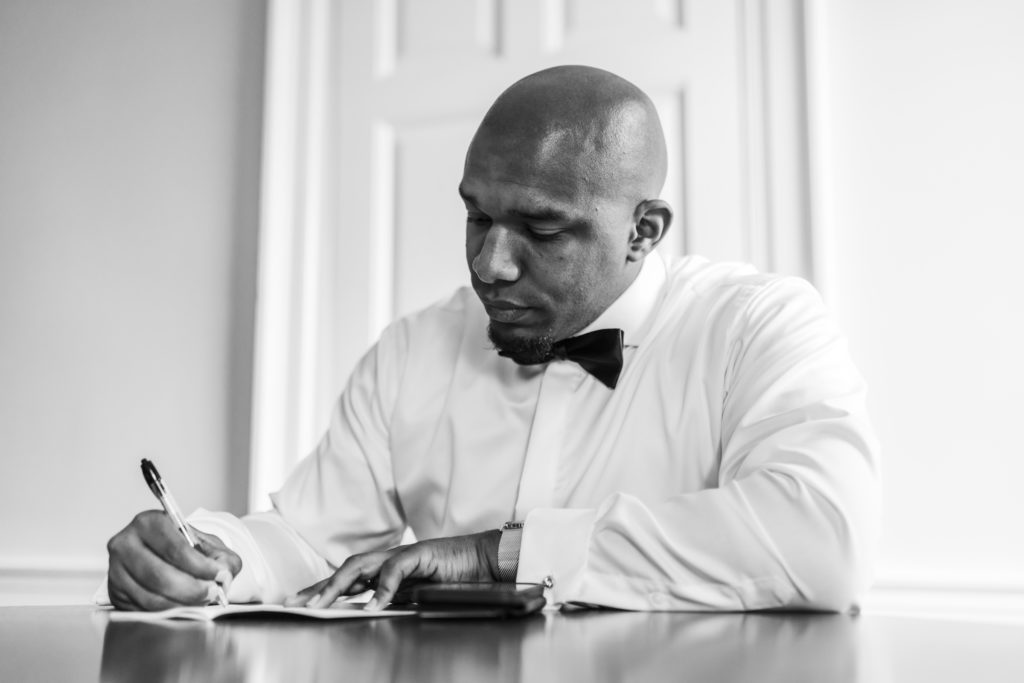 groom writing vows and letter to bride before spring black tie montalto wedding ceremony