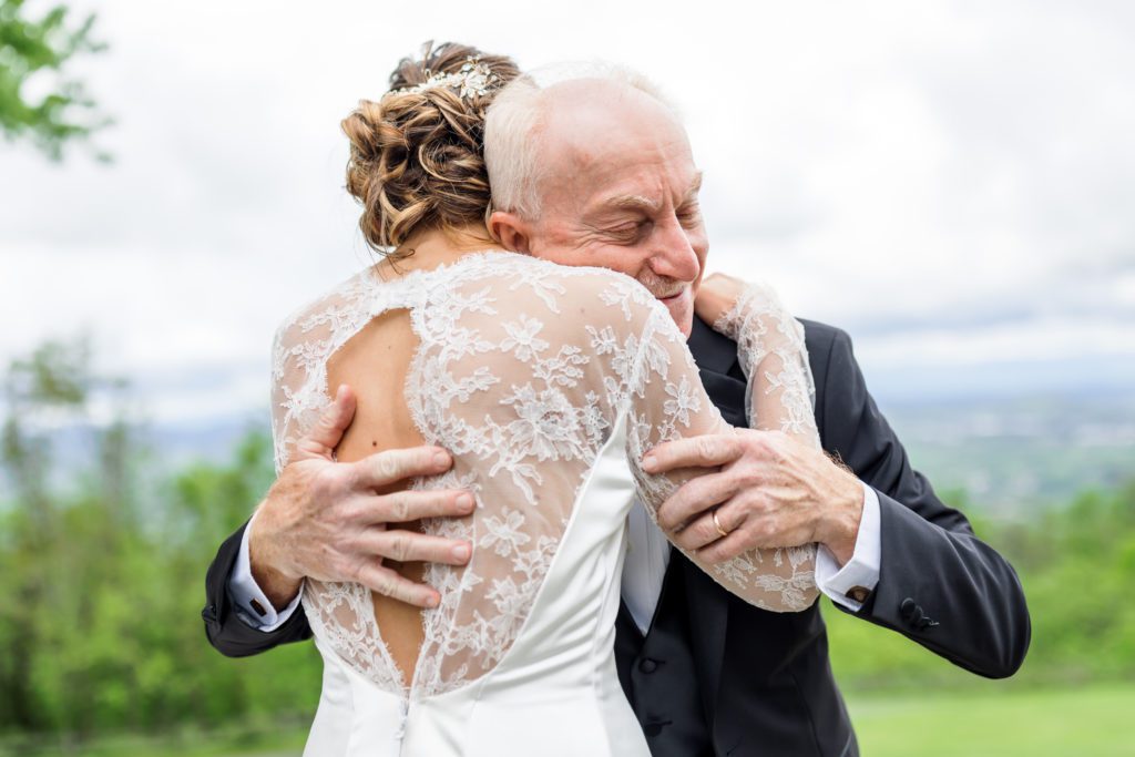 bride hugging father after first look before wedding ceremony