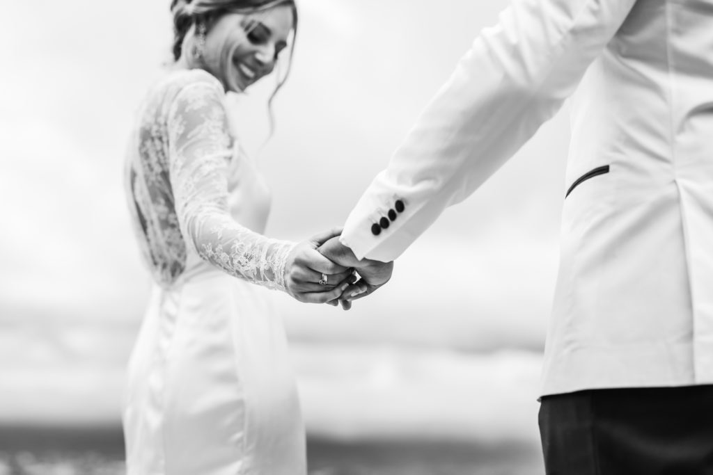 bride holding groom's hand before wedding ceremony