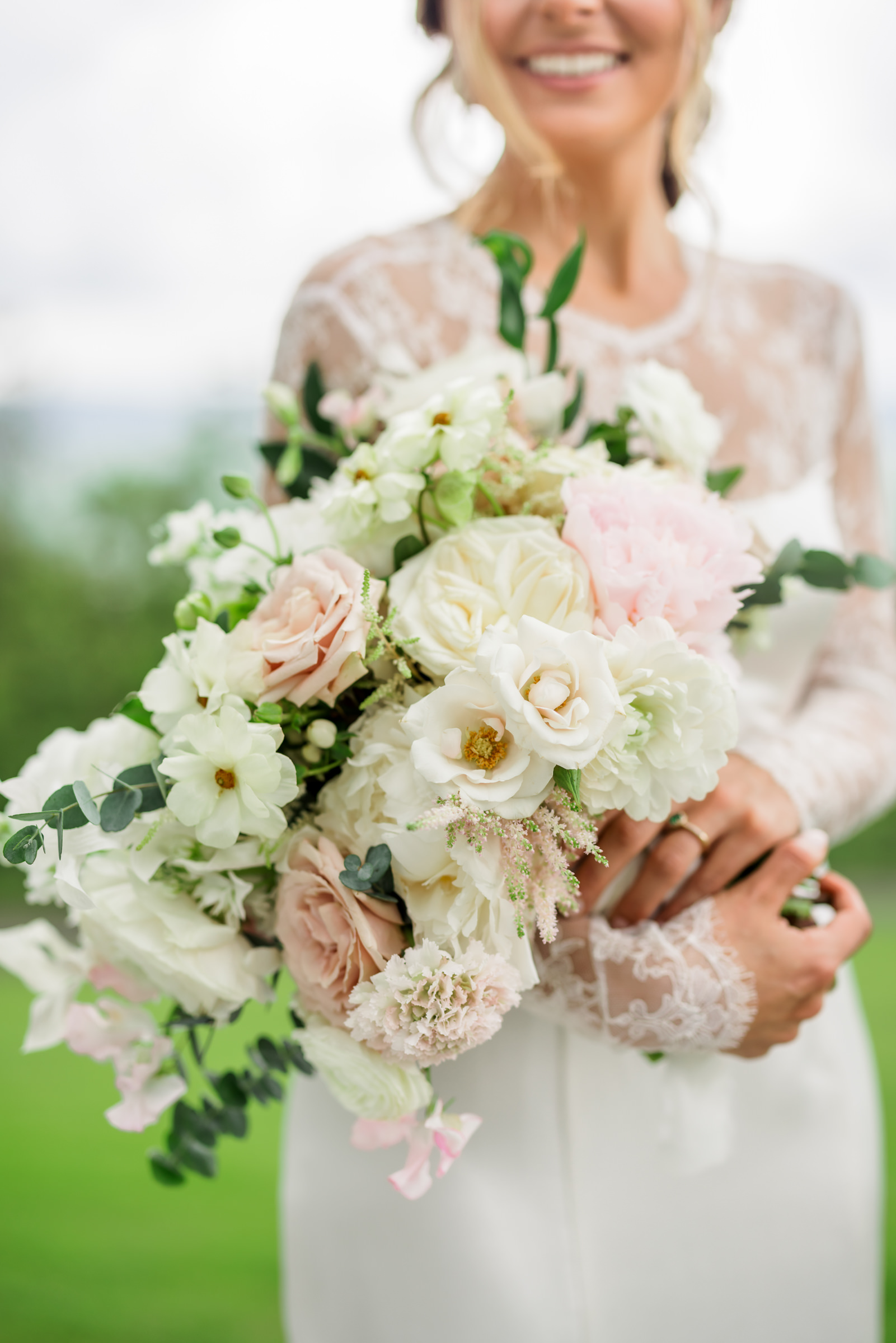 bride holding bouquet with white and pink flowers